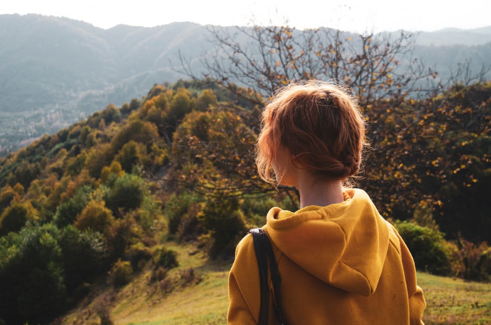 Back View of a Woman Wearing a Yellow Hoodie