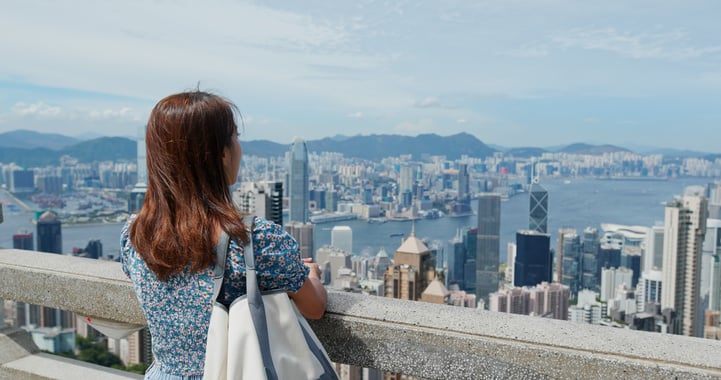 Back View of Woman Overlooking City Skyline