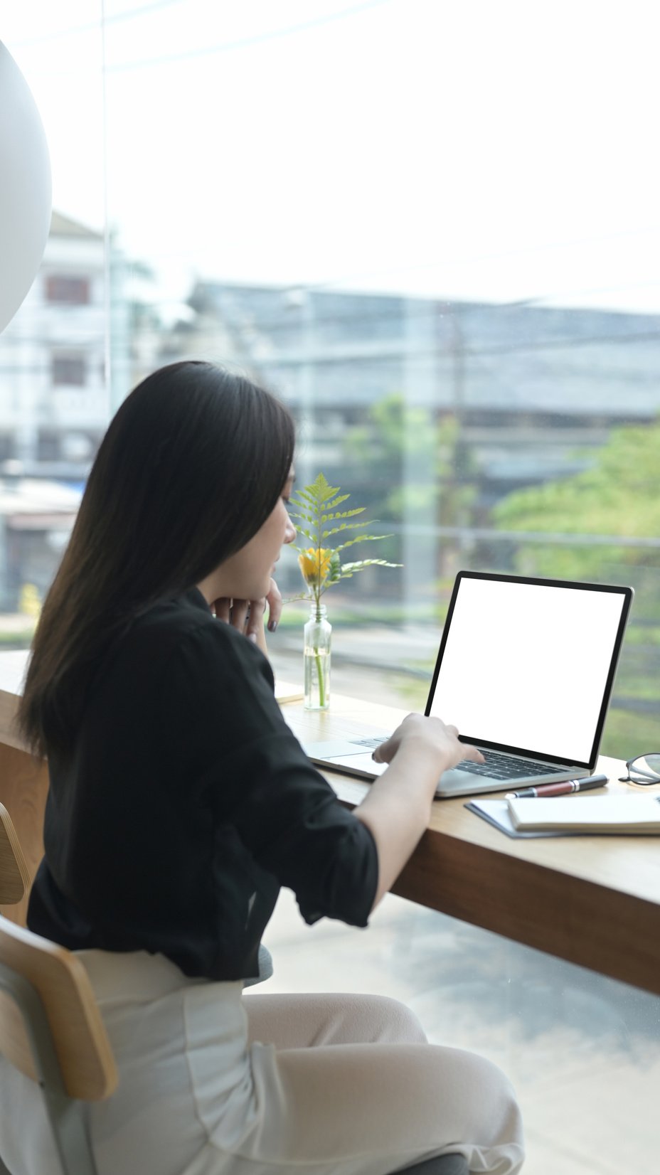 Back View of Young Female Freelancer Working Online with Compute